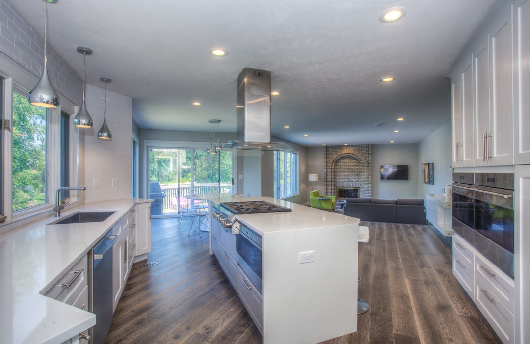 Interior photo comparing mid-grade vs high-end finish selections: cabinetry, countertops, flooring, and lighting packages
