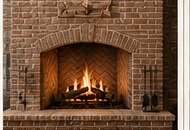 Hand-crafted brick fireplace finish with arched firebox.